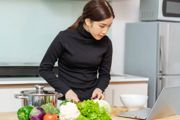 istock Asian woman cooking 1288231183