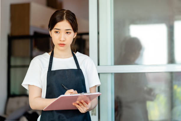 istock Asian woman waitress 1288231273