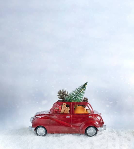 istock Christmas red car carying christmas tree and decorations. 1288232453