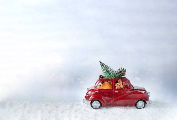 istock Christmas red car carying christmas tree and decorations 1288232537
