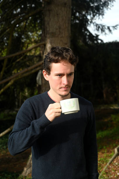 istock Young man drinking a cup of tea outdoor 1288233031