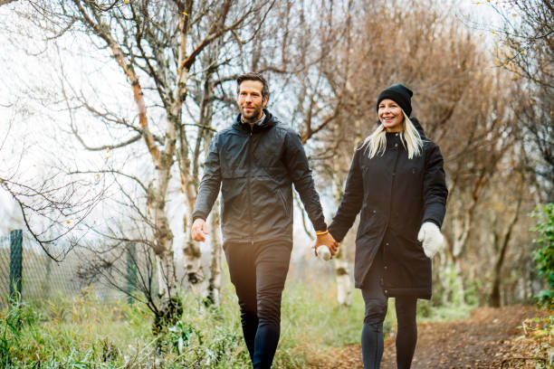 istock Happy couple walking at park during autumn 1288233864