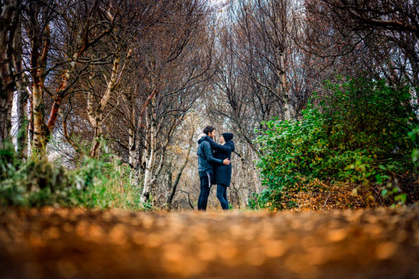 istock Couple embracing at park during autumn 1288233932