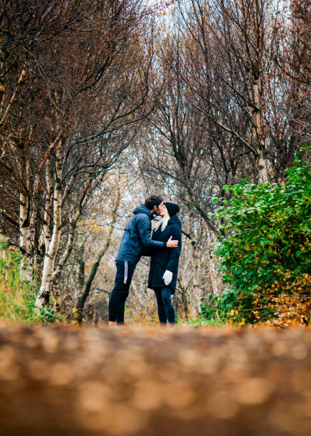 istock Affectionate couple kissing at park during autumn 1288233937