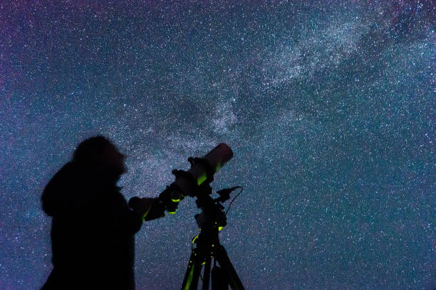 Silhouette of a woman with a telescope Silhouette of a woman with a telescope against the background of the milky way astronomer photos stock pictures, royalty-free photos & images
