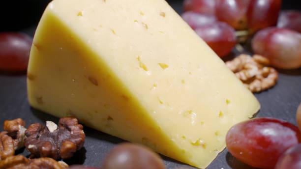 istock Assorted cheeses with nuts and dried fruits on the table. Rotating video 1288235729