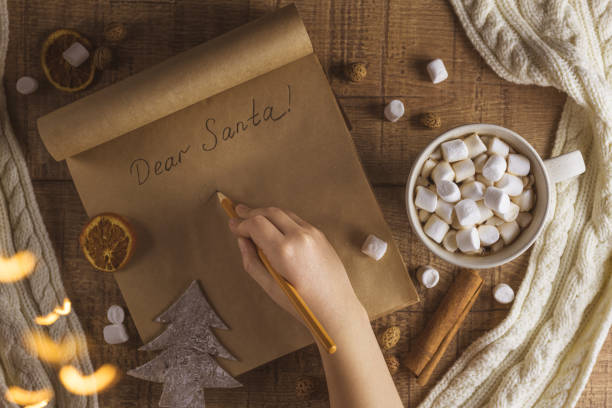 istock Christmas concept with cup of coffee with marshmallows and notepad 1288237219
