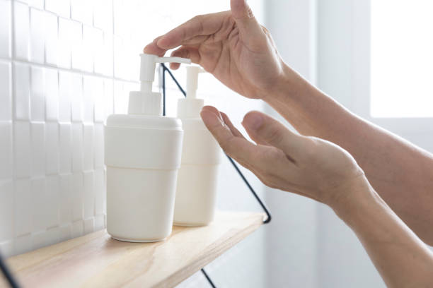 istock A man hand presses on a disinfectant gel in a white plastic bottle. 1288238160