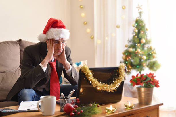 istock Angry man in suit working at home at christmas 1288242101