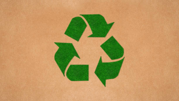 istock Green Recycling Symbol on Recycled Paper 1288244201