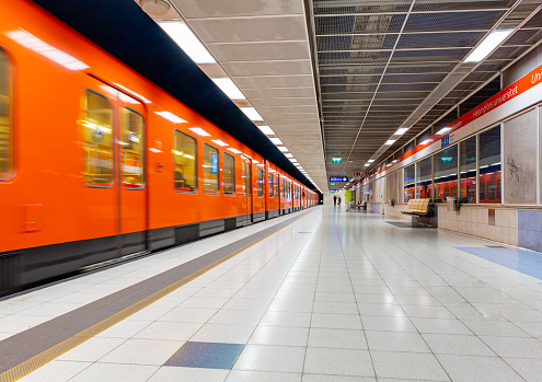 This image shows interiors of Helsinki metro, station with trains, Finland. Red orange trains can be seen in the image too.