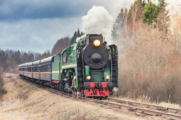 istock Steam train moves at sunset autumn time. 1288245766