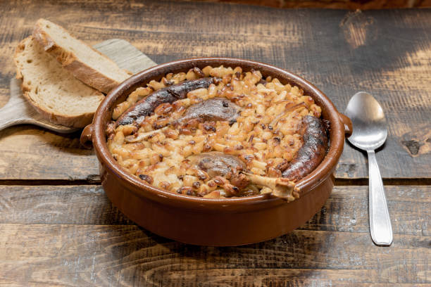 French specialty: cassoulet, a meal with white beans, duck leg, sausage and bacon French specialty: cassoulet, a meal with white beans, duck leg, sausage and bacon. andorra photos stock pictures, royalty-free photos & images