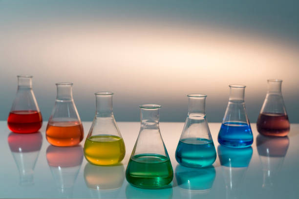 istock Scientific laboratory glass erlenmeyer flask filled with colorful liquid forming rainbow. 1288247372