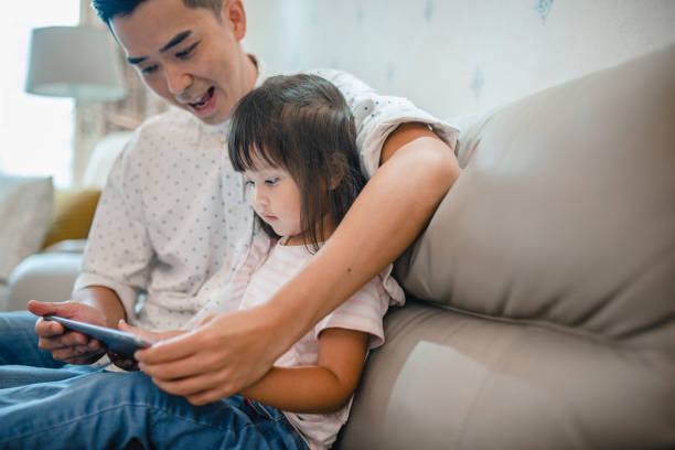 istock Chinese Father with 3 Year Old Digital Native Daughter 1288247463