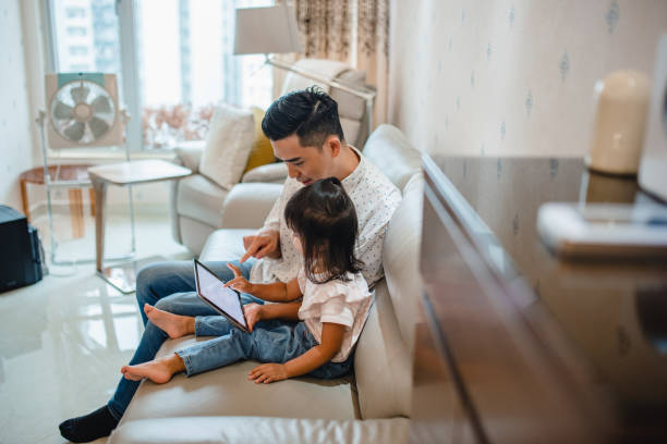 istock Chinese Father and Toddler Daughter Using Digital Tablet 1288247467