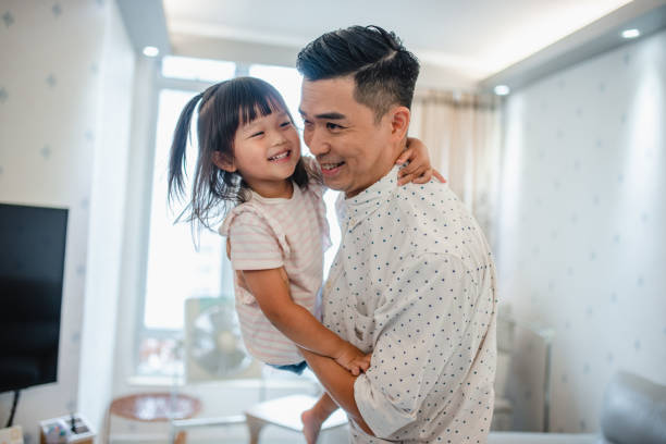 istock Happy Chinese Toddler Playing at Home with Father 1288247471