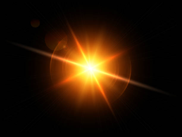 istock Gold sun with lens flare, glittering shiny star on black 1288248465
