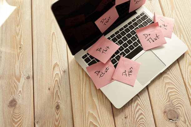 istock Image of laptop full of sticky notes reminders on screen. Work overload concept image. Coworking or working at home concept image. 1288248715
