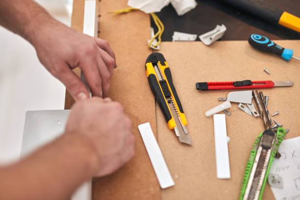 istock Handyman using scalpel cutter for fixing household things. 1288248835