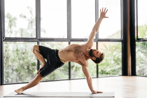 istock Yoga men workout in studio in front of a window 1288248934