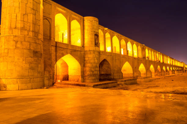 Arches of night view with light effect of Allahverdi Khan Bridge, also named  Si-o-seh pol bridge across the Zayanderud river in Isfahan, Iran, a famous historic building in Persian History stock photo
