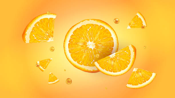 istock Slices of fresh orange with drops of juice in flight. 1288251240