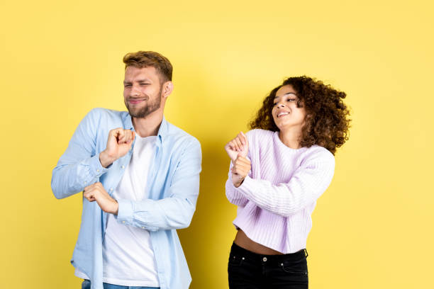 istock Mixed race friends standing on yellow background 1288253466