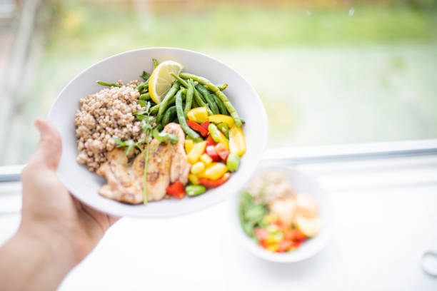 Healthy protein breakfast, eggs, mushrooms, avocado, cherry tomato, onion, garlic and asparagus, served on a ceramic plate, on wooden home, bar or restaurant table, a close up image with a copy space