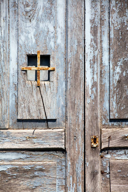 istock Ancient blue wooden closed door, peephole, keyhole. 1288255652