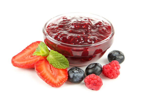 istock Sweet jam in bowl with berries isolated on white background 1288255737