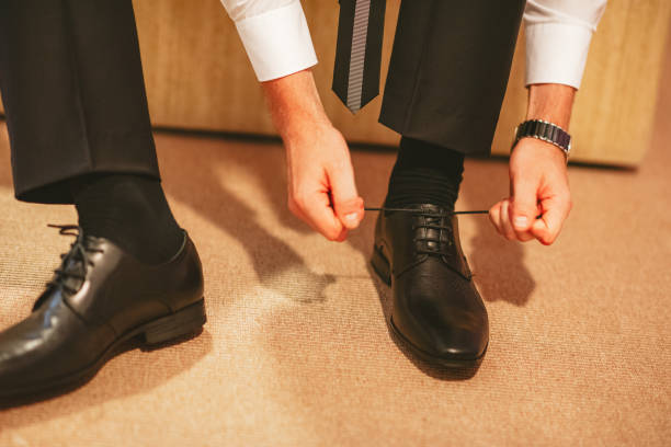 istock Groom tying a shoe 1288256194