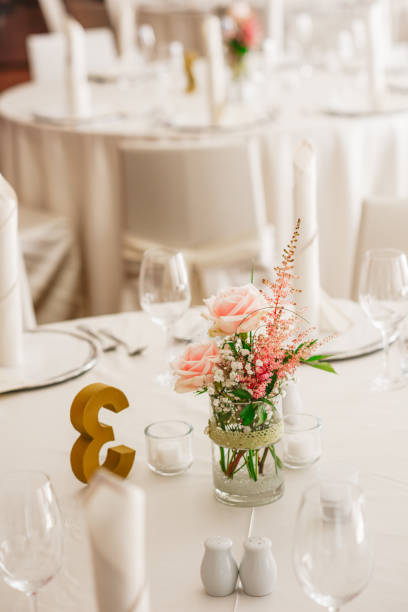 istock Table detail of an event party or wedding reception. luxury elegant table setting dinner in a restaurant. glasses and dishes 1288256287