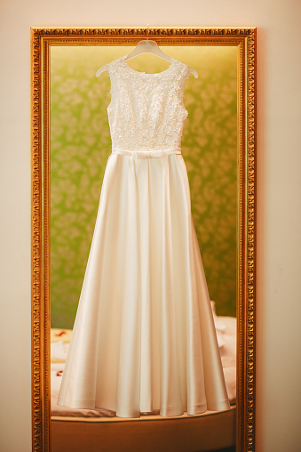 Wedding dress hanging on the mirror
