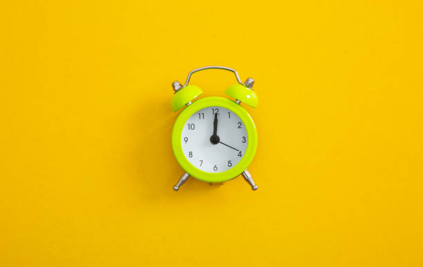 istock An Alarm clock on a color background. 1288259089