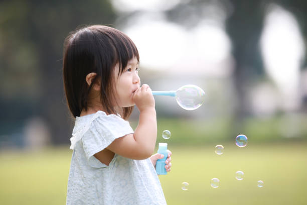 Girl playing with soap bubbles