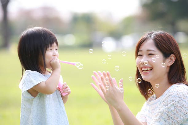 istock Parents and children playing with soap bubbles 1288260332