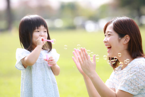 istock Parents and children playing with soap bubbles 1288260336