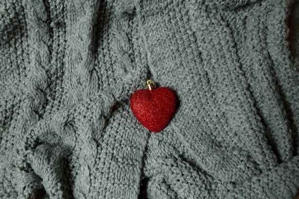 istock red heart toy on gray knitted fabric 1288262163