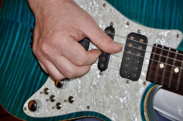 istock Guitarist paying on blue electrical guitar in studio. Closeup shot 1288263297