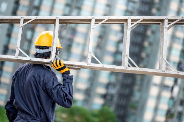 istock Maintenance worker man carrying aluminium ladder 1288264467