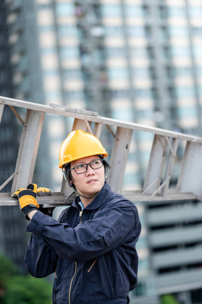 istock Maintenance worker man carrying aluminium ladder 1288264512