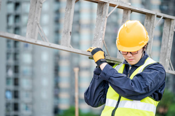 istock Maintenance worker man carrying aluminium ladder 1288265857