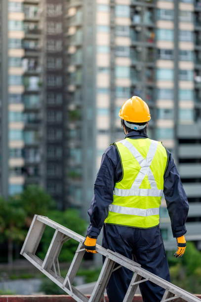 istock Maintenance worker man carrying aluminium ladder 1288265860