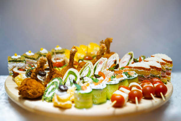 Waiter serving a buffet table full of delicious food