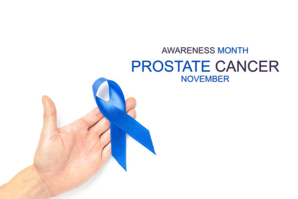 istock Prostate awareness. Blue ribbon in hands isolated on white background. Awareness prostate cancer of men health in November. Healthcare, International men, Father day. 1288267220