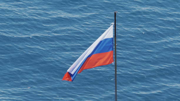 istock Russian flag against backdrop of sea waves 1288267323
