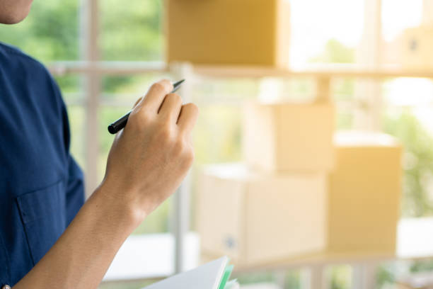 istock Young man starts small business (SME) by delivering products packed into boxes through a logistics system from home office, package delivery, online marketing,  e-commerce concept. 1288268744