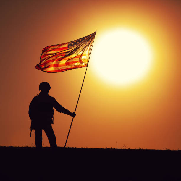 istock USA army soldier with flag on sunset background 1288268966