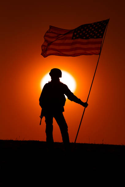 istock USA army soldier with flag on sunset background 1288268978